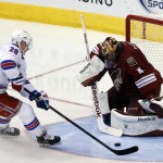 New York Rangers left wing Chris Kreider (20) scores on Arizona Coyotes goalie Mike Smith during the second period of an NHL hockey game, Saturday, Feb. 14, 2015, in Glendale, Ariz. (AP Photo/Rick Scuteri)