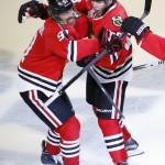 Chicago Blackhawks' Patrick Kane, right, is congratulated by teammate Brad Richards after scoring during the third period in Game 6 of the NHL hockey Stanley Cup Final series against the Tampa Bay Lightning on Monday, June 15, 2015, in Chicago. (AP Photo/Charles Rex Arbogast)