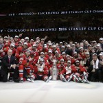 Members of the Chicago Blackhawks pose for pictures as they celebrate after defeating the Tampa Bay Lightning in Game 6 of the NHL hockey Stanley Cup Final series on Monday, June 15, 2015, in Chicago. The Blackhawks defeated the Lightning 2-0 to win the series 4-2. (AP Photo/Nam Y. Huh)
