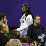 Seattle Seahawks' Marshawn Lynch leaves at the beginning of media day for NFL Super Bowl XLIX football game Tuesday, Jan. 27, 2015, in Phoenix. (AP Photo/Charlie Riedel)
