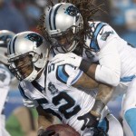 Carolina Panthers' Tre Boston, top, celebrates Kevin Reddick's, bottom, after Reddick's fumble recovery against the Arizona Cardinals in the second half of an NFL wild card playoff football game in Charlotte, N.C., Saturday, Jan. 3, 2015. (AP Photo/Bob Leverone)