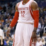 Houston Rockets' Dwight Howard pauses after missing a shot during the first half of an NBA basketball game against the Phoenix Suns on Friday, Jan. 23, 2015, in Phoenix. Howard left the game moments later with a sprained ankle. (AP Photo/Ross D. Franklin)