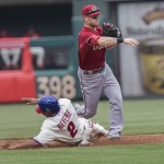 Philadelphia Phillies' Ben Revere (2) is out at second as Arizona Diamondbacks shortstop Chris Owings (16) throws to first for the out on Philadelphia Phillies' Andres Blanco on a double play in the third inning of a baseball game, Sunday, May 17, 2015, in Philadelphia. (AP Photo/Laurence Kesterson)
