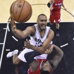 San Antonio Spurs' Boris Diaw, center, drives over Los Angeles Clippers' Glen Davis (0) to score during the second half of Game 3 in an NBA basketball first-round playoff series, Friday, April 24, 2015, in San Antonio. (AP Photo/Larry Smith, Pool)