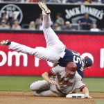 San Diego Padres second baseman Cory Spangenberg is upended by Arizona Diamondbacks' Nick Ahmed while relaying to first to complete a double play in the first inning of a baseball game Saturday, June 27, 2015, in San Diego. Paul Goldschmidt was out at first. (AP Photo/Lenny Ignelzi)
