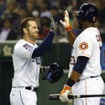 MLB All-Stars' Evan Longoria, left, celebrates with teammate Chris Carter after hitting a solo shot off Japan's Minoru Iwata in the sixth inning of Game 4 of their exhibition baseball series at Tokyo Dome in Tokyo, Sunday, Nov. 16, 2014. (AP Photo/Toru Takahashi)