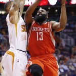 Houston Rockets' James Harden (13) drives past Phoenix Suns' Markieff Morris, left, to the basket during the first half of an NBA basketball game Tuesday, Feb. 10, 2015, in Phoenix. (AP Photo/Ross D. Franklin)