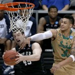 Butler's Andrew Chrabascz (45) is fouled by Notre Dame's Zach Auguste (30) as he shoots during the second half of an NCAA tournament third round college basketball game, Saturday, March 21, 2015, in Pittsburgh. (AP Photo/Gene J. Puskar)