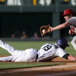 Arizona Diamondbacks first baseman Nick Evans, right, fields a pickoff throw as Colorado Rockies' Charlie Blackmon dives back into first base in the first inning of a baseball game in Denver on Tuesday, June 3, 2014. (AP Photo/David Zalubowski)