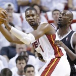 Miami Heat center Chris Bosh (1) looks for an open teammate past Brooklyn Nets center Kevin Garnett (2) during the second half of Game 2 of an Eastern Conference semifinal NBA basketball game, Thursday, May 8, 2014 in Miami. The Heat defeated the Nets 94-82. (AP Photo/Wilfredo Lee)