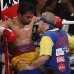 Manny Pacquiao, left, listens to trainer Freddie Roach between rounds of his welterweight title fight against Floyd Mayweather Jr. on Saturday, May 2, 2015 in Las Vegas. (AP Photo/Eric Jamison)