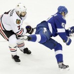 Tampa Bay Lightning center Valtteri Filppula (51) trips as he passes off the puck against Chicago Blackhawks defenseman Brent Seabrook (7) during the second period of Game 5 of the NHL hockey Stanley Cup Final, Saturday, June 13, 2015, in Tampa, Fla. (AP Photo/John Raoux)