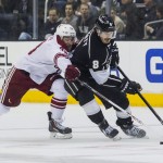  Los Angeles Kings defenseman Drew Doughty (8) and Phoenix Coyotes forward Brandon Mcmillan (38) vie for the puck during the first period of an NHL hockey game, Wednesday, April 2, 2014, in Los Angeles. (AP Photo/Ringo H.W. Chiu)