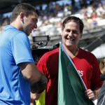Indianapolis Colts quarterback Andrew Luck, left, shakes hands with Dallas Mavericks owner Mark Cuban after presenting him the green flag that Cuban will use to start of the 98th running of the Indianapolis 500 IndyCar auto race at the Indianapolis Motor Speedway in Indianapolis, Sunday, May 25, 2014. (AP Photo/AJ Mast)