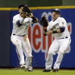  Milwaukee Brewers' Carlos Gomez, left, and Caleb Gindl nearly collide as Gomez catches a ball hit by Arizona Diamondbacks' Martin Prado during the sixth inning of a baseball game Monday, May 5, 2014, in Milwaukee. (AP Photo/Morry Gash)