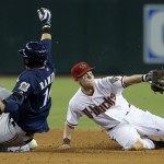  Milwaukee Brewers' Aramis Ramirez, left, slides safely into second base with a double as Arizona Diamondbacks' Chris Owings, right, dives to field the ball during the fifth inning of a baseball game on Thursday, June 19, 2014, in Phoenix. (AP Photo/Ross D. Franklin)
