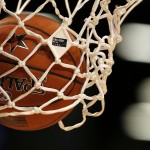 The NBA All-Star Game logo is seen on the net as World Team's Giannis Antetokounmpo, of the Milwaukee Bucks, shoots a free-throw during the second half of the Rising Stars Challenge against the U.S.Team, Friday, Feb. 13, 2015, in New York. (AP Photo/Julio Cortez)