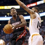 Miami Heat's Norris Cole, left, drives past Phoenix Suns' Marcus Morris (15) during the first half of an NBA basketball game Tuesday, Dec. 9, 2014, in Phoenix. (AP Photo/Ross D. Franklin)
