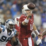 Arizona Cardinals' Ryan Lindley (14) throws a pass under pressure from Carolina Panthers' Charles Johnson (95) in the first half of an NFL wild card playoff football game in Charlotte, N.C., Saturday, Jan. 3, 2015. (AP Photo/Mike McCarn)