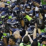 Seattle Seahawks team members huddle before the NFL Super Bowl XLIX football game against the New England Patriots, Sunday, Feb. 1, 2015, in Glendale, Ariz. (AP Photo/Charlie Riedel)