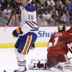  Edmonton Oilers' Justin Schultz (19) celebrates his goal against Phoenix Coyotes' Thomas Greiss (1), of Germany, during the first period of an NHL hockey game, Friday, April 4, 2014, in Glendale, Ariz. (AP Photo/Ross D. Franklin)