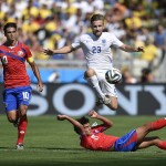 Chased by Costa Rica's Bryan Ruiz, left, England's Luke Shaw controls the ball over Costa Rica's Yeltsin Tejeda during the group D World Cup soccer match between Costa Rica and England at the Mineirao Stadium in Belo Horizonte, Brazil, Tuesday, June 24, 2014. (AP Photo/Martin Meissner)