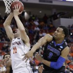 Virginia forward Evan Nolte (11) shoots against Memphis guard Chris Crawford (3) during the second half of an NCAA college basketball third-round tournament game, Sunday, March 23, 2014, in Raleigh, N.C. (AP Photo/Chuck Burton)