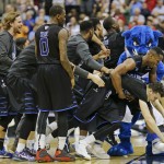 Georgia State players celebrate as they surround R.J. Hunter, right, after he made the game-winning shot against Baylor late in the second half in the second round of the NCAA college basketball tournament, Thursday, March 19, 2015, in Jacksonville, Fla. Georgia State won 57-56. (AP Photo/Chris O'Meara
