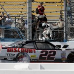 Joey Logano does a burn out and takes the checkered flag after winning the NASCAR XFINITY Series auto race on Saturday, March 14, 2015, in Avondale, Ariz. (AP Photo/Rick Scuteri)