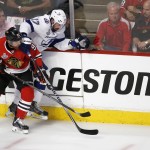 Chicago Blackhawks' Brad Richards, left, and Tampa Bay Lightning's Alex Killorn chase after a loose puck during the first period in Game 6 of the NHL hockey Stanley Cup Final series on Monday, June 15, 2015, in Chicago. (AP Photo/Charles Rex Arbogast)