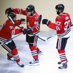 Chicago Blackhawks' Patrick Kane, center, is congratulated by teammates Brad Richards, left, and Johnny Oduya, of Sweden, during the third period in Game 6 of the NHL hockey Stanley Cup Final series against the Tampa Bay Lightning on Monday, June 15, 2015, in Chicago. (AP Photo/Charles Rex Arbogast)
