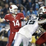 Arizona Cardinals' Ryan Lindley (14) looks to pass under pressure from Carolina Panthers' Charles Johnson (95) in the first half of an NFL wild card playoff football game in Charlotte, N.C., Saturday, Jan. 3, 2015. (AP Photo/Bob Leverone)