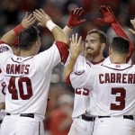 Washington Nationals' Adam LaRoche, second from right, celebrates with teammates Anthony Rendon (6), Wilson Ramos (40) and Asdrubal Cabrera (3) after hitting a game-winning solo home run during the 11th inning of a baseball game against the Arizona Diamondbacks, Monday, Aug. 18, 2014, in Washington. The Nationals won 5-4 in 11 innings. (AP Photo/Luis M. Alvarez)