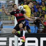 Germany's Miroslav Klose, left, and Brazil's David Luiz battle for the ball during the World Cup semifinal soccer match between Brazil and Germany at the Mineirao Stadium in Belo Horizonte, Brazil, Tuesday, July 8, 2014. (AP Photo/Matthias Schrader)