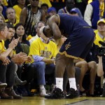 Cleveland Cavaliers forward LeBron James reacts after being hit in the face during the second half of Game 2 of basketball's NBA Finals against the Golden State Warriors in Oakland, Calif., Sunday, June 7, 2015. (AP Photo/Ben Margot)