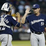 Milwaukee Brewers' Zach Duke (59) high-fives with catcher Martin Maldonado after the final out in the ninth inning of a baseball game against the Arizona Diamondbacks on Monday, June 16, 2014, in Phoenix. The Brewers defeated the Diamondbacks 9-3. (AP Photo/Ross D. Franklin)