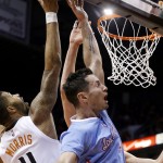 Phoenix Suns' Markieff Morris (11) blocks the shot of Los Angeles Clippers' J.J. Redick, right, during the first half of an NBA basketball game Sunday, Jan. 25, 2015, in Phoenix. (AP Photo/Ross D. Franklin)