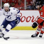 Tampa Bay Lightning's Ryan Callahan, left, handles the puck as Chicago Blackhawks' Duncan Keith watches during the first period in Game 6 of the NHL hockey Stanley Cup Final series on Monday, June 15, 2015, in Chicago. (AP Photo/Nam Y. Huh)