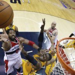 Washington Wizards forward Nene shoots past Indiana Pacers center Roy Hibbert (55) during the first half in Game 6 of an Eastern Conference semifinal NBA basketball playoff series in Washington, Thursday, May 15, 2014. (AP Photo/Alex Brandon)