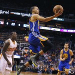 Golden State Warriors guard Stephen Curry (30) shoots against the Phoenix Suns in the second quarter of an NBA basketball game, Sunday, Nov. 9, 2014, in Phoenix. (AP Photo/Rick Scuteri)