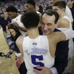Duke head coach Mike Krzyzewski hugs Tyus Jones (5) after a college basketball regional final game in the NCAA Tournament Sunday, March 29, 2015, in Houston. Duke won 66-52 to advance to the Final Four. (AP Photo/Charlie Riedel)
