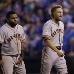 San Francisco Giants Hunter Pence, right, and Pablo Sandoval walk back to the dugout after Pence grounded out during the sixth inning of Game 6 of baseball's World Series Tuesday, Oct. 28, 2014, in Kansas City, Mo. Sandoval was walked by Kansas City Royals Yordano Ventura. (AP Photo/Charlie Neibergall)