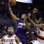  Phoenix Suns forward P.J. Tucker, middle, goes to the basket between Portland Trail Blazers' Thomas Robinson, right, and Mo Williams during the first half of an NBA basketball game in Portland, Ore., Friday, April 4, 2014. (AP Photo/Don Ryan)