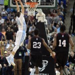 North Carolina guard/forward Justin Jackson (44) goes up for a dunk after getting past Harvard guard Wesley Saunders (23) and forward Steve Moundou-Missi (14) during the second half of an NCAA tournament second round college basketball game Thursday, March 19, 2015, in Jacksonville, Fla. North Carolina won the game 67-65. (AP Photo/Rick Wilson)