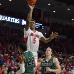 Arizona forward Stanley Johnson (5) shoots over Utah Valley forward Chad Ross (22) during the second half of an NCAA college basketball game, Tuesday, Dec. 9, 2014, in Tucson, Ariz. (AP Photo/Rick Scuteri)