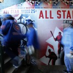 Baseball fans head to their seats past a mural of the 1947 All-Star Game program, on the 100th anniversary of the first baseball game at Wrigley Field, before a game between the Arizona Diamondbacks and Chicago Cubs, Wednesday, April 23, 2014, in Chicago. (AP Photo/Charles Rex Arbogast)