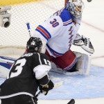  New York Rangers goalie Henrik Lundqvist, of Sweden, top, blocks a shot by Los Angeles Kings left wing Kyle Clifford during the third period in Game 1 of the NHL hockey Stanley Cup Finals, Wednesday, June 4, 2014, in Los Angeles. (AP Photo/Mark J. Terrill)