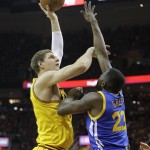 Cleveland Cavaliers center Timofey Mozgov (20), left, shoots over Golden State Warriors forward Draymond Green (23) during the first half of Game 4 of basketball's NBA Finals in Cleveland, Thursday, June 11, 2015. (AP Photo/Tony Dejak)