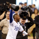 Kansas City Royals' Jarrod Dyson runs with the trophy after the Royals defeated the Baltimore Orioles to win the American League baseball championship series Wednesday, Oct. 15, 2014, in Kansas City, Mo. The Royals advance to the World Series.(AP Photo/Orlin Wagner)