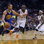 Golden State Warriors guard Stephen Curry (30) drives past Phoenix Suns forward Anthony Tolliver (40) and guard Isaiah Thomas (3) in the first quarter of an NBA basketball game, Sunday, Nov. 9, 2014, in Phoenix. (AP Photo/Rick Scuteri)